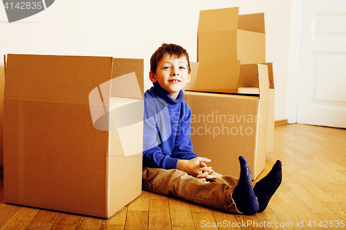 Image of little cute boy in empty room, remoove to new house. home alone, lifestyle people concept