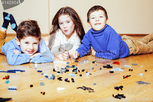 Image of funny cute children playing lego at home, boys and girl smiling, first education role lifestyle