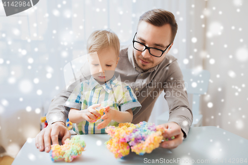 Image of father and son playing with ball clay at home