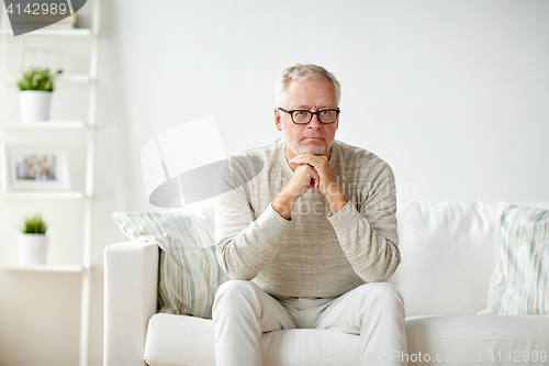 Image of close up of senior man in glasses thinking