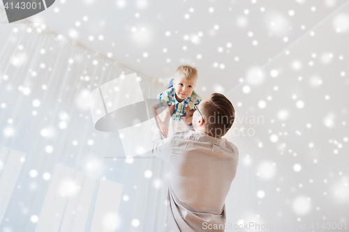 Image of father with son playing and having fun at home