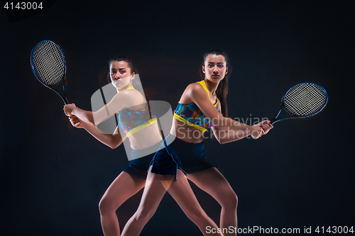 Image of Portrait of beautiful girl tennis player with a racket on dark background