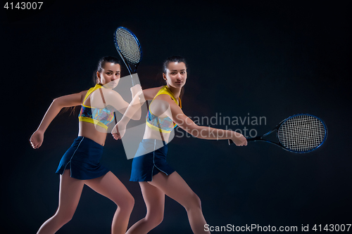 Image of Portrait of beautiful girl tennis player with a racket on dark background