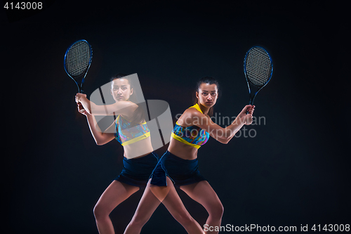 Image of Portrait of beautiful girl tennis player with a racket on dark background