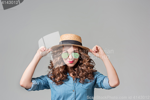 Image of girl in sunglasses and straw