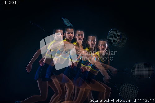 Image of Portrait of beautiful girl tennis player with a racket on dark background
