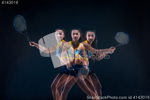 Image of Portrait of beautiful girl tennis player with a racket on dark background