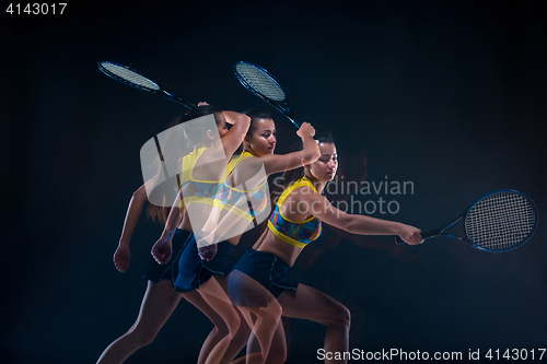 Image of Portrait of beautiful girl tennis player with a racket on dark background