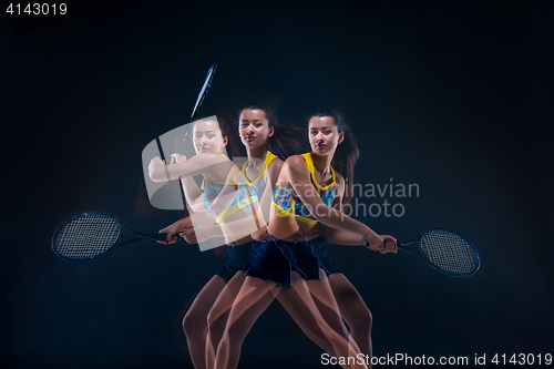 Image of Portrait of beautiful girl tennis player with a racket on dark background