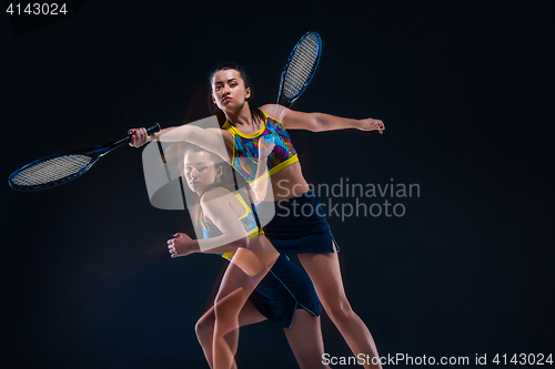 Image of Portrait of beautiful girl tennis player with a racket on dark background