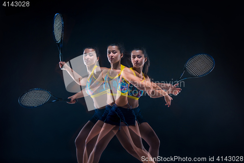 Image of Portrait of beautiful girl tennis player with a racket on dark background