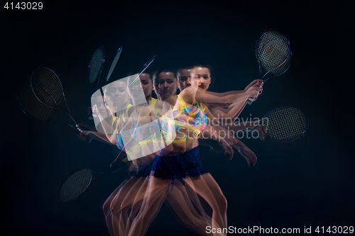 Image of Portrait of beautiful girl tennis player with a racket on dark background