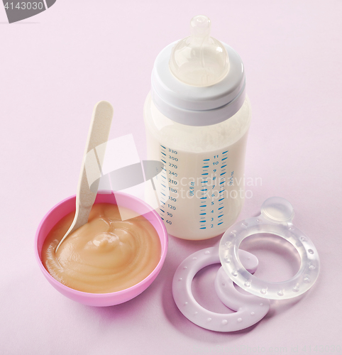 Image of baby milk bottle and pureed apple
