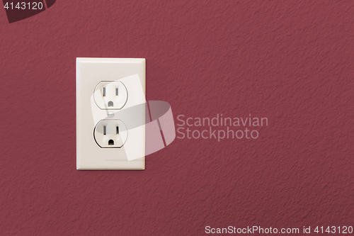 Image of Electrical Sockets In Colorful Burgundy Wall