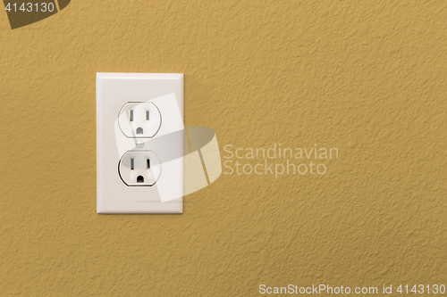 Image of Electrical Sockets In Colorful Mustard Yellow Wall