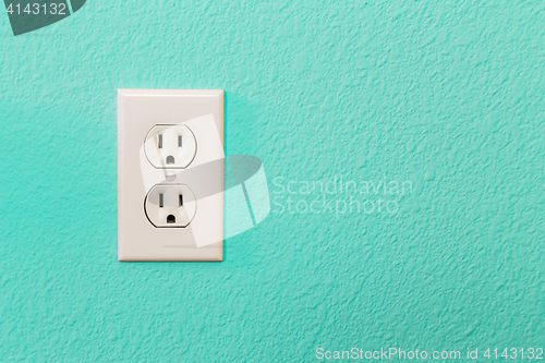 Image of Electrical Sockets In Colorful Bright Teal Wall