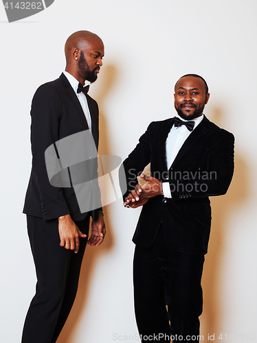 Image of two afro-american businessmen in black suits emotional posing, g