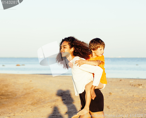 Image of pretty diverse nation and age friends on sea coast having fun, lifestyle people concept on beach vacations