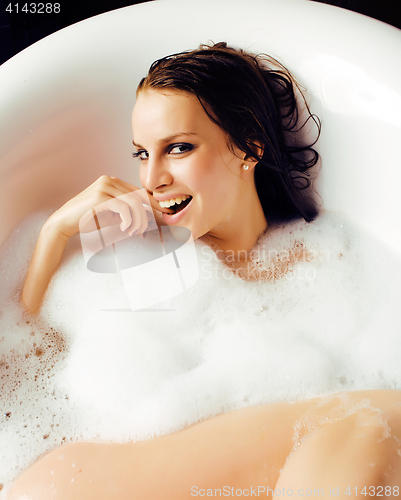 Image of young cute sweet brunette woman taking bath, happy smiling peopl