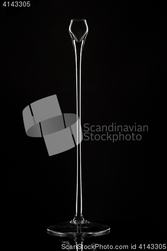 Image of Tall glass candlesticks against black background