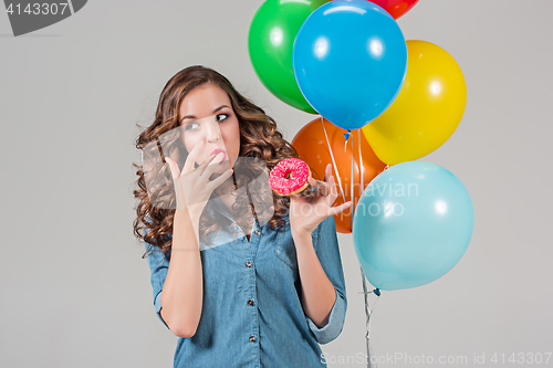 Image of girl with bunch of colorful balloons