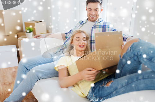 Image of happy couple with big cardboard boxes at new home