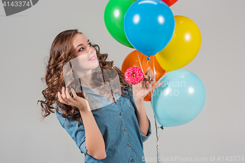 Image of girl with bunch of colorful balloons