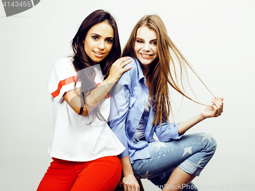 Image of best friends teenage girls together having fun, posing emotional on white background, besties happy smiling, lifestyle people concept, blond and brunette multi nations