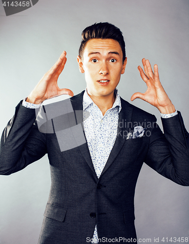 Image of young pretty business man standing on white background, modern hairstyle, posing emotional, lifestyle people concept