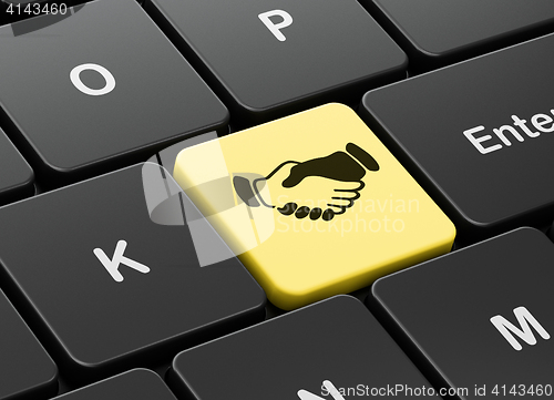 Image of Finance concept: Handshake on computer keyboard background