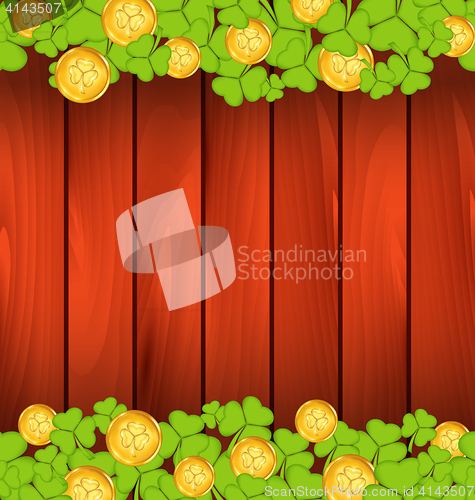 Image of Clovers and golden coins on brown wooden background for St. Patr