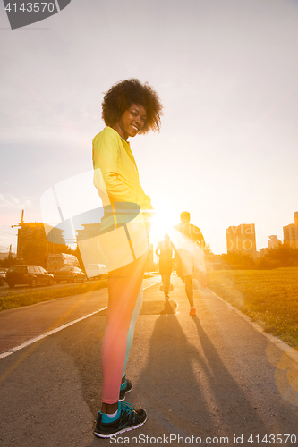 Image of Portrait of sporty young african american woman running outdoors