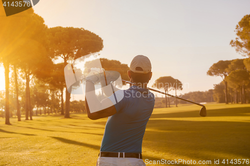 Image of golf player hitting shot with club