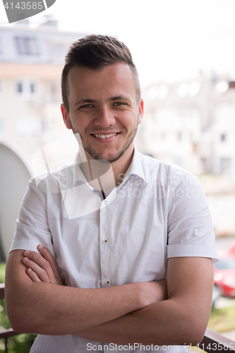 Image of man standing at balcony