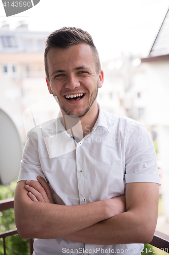 Image of man standing at balcony