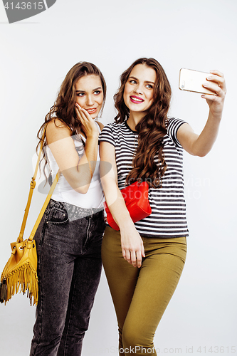 Image of two best friends teenage girls together having fun, posing emotional on white background, besties happy smiling, making selfie, lifestyle people concept