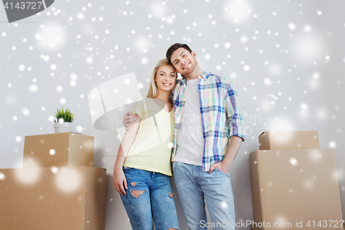 Image of smiling couple with big boxes moving to new home