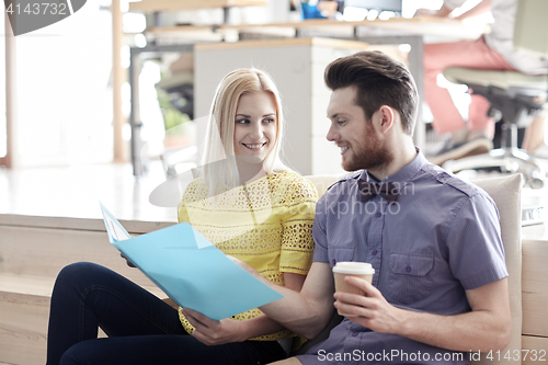 Image of office workers with folder and coffee