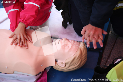 Image of Practicing CPR chest compressioon on a dummy