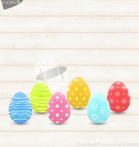 Image of wooden background with colorful traditional eggs for Easter