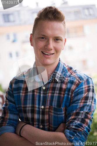 Image of man standing at balcony