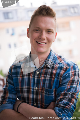 Image of man standing at balcony