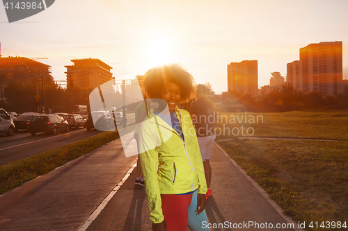 Image of Portrait of sporty young african american woman running outdoors