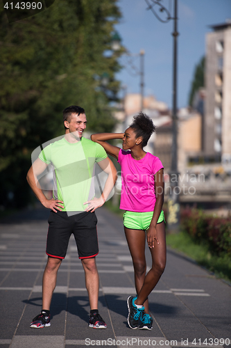 Image of portrait of young multietnic jogging couple ready to run