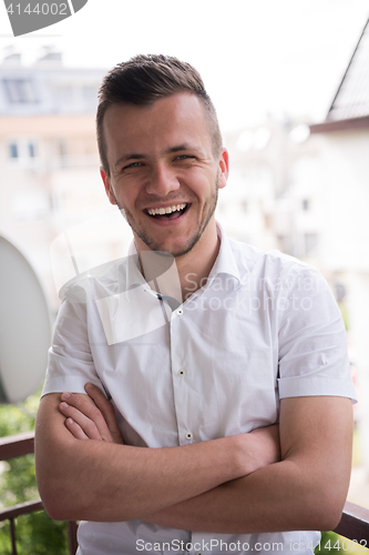 Image of man standing at balcony