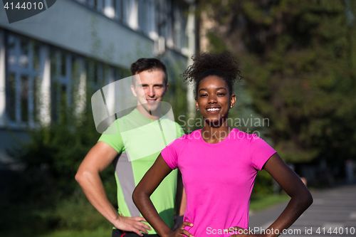 Image of portrait of young multietnic jogging couple ready to run