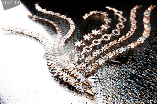 Image of Golden Bracelets On A Glass