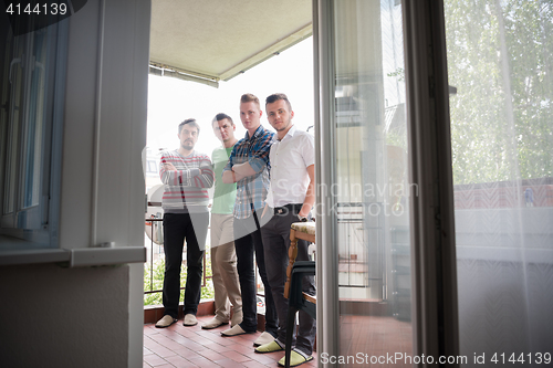 Image of group of people standing at balcony