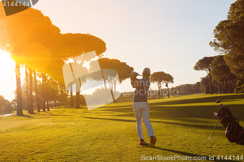 Image of golf player hitting shot with club