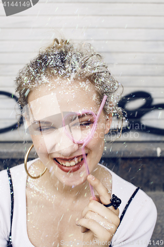 Image of young pretty party girl smiling covered with glitter tinsel, fashion dress, stylish make up, lifestyle people concept close up